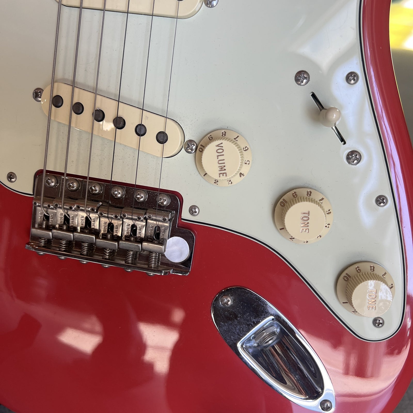 Close up of the Fiesta Red alder body, mint green pickguard, and pure vintage pickups on the 1961 Stratocaster