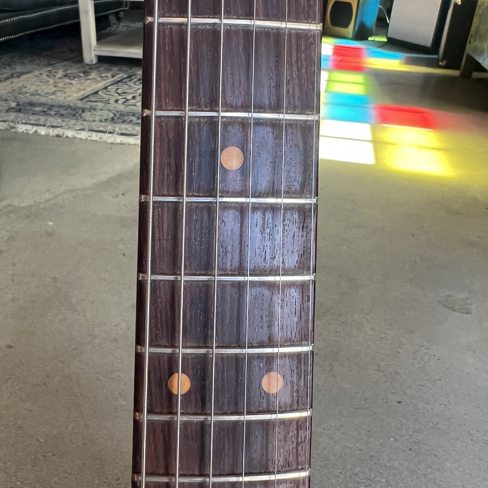 Close up of the slab rosewood fingerboard with clay dot inlays on the 1961 Stratocaster neck