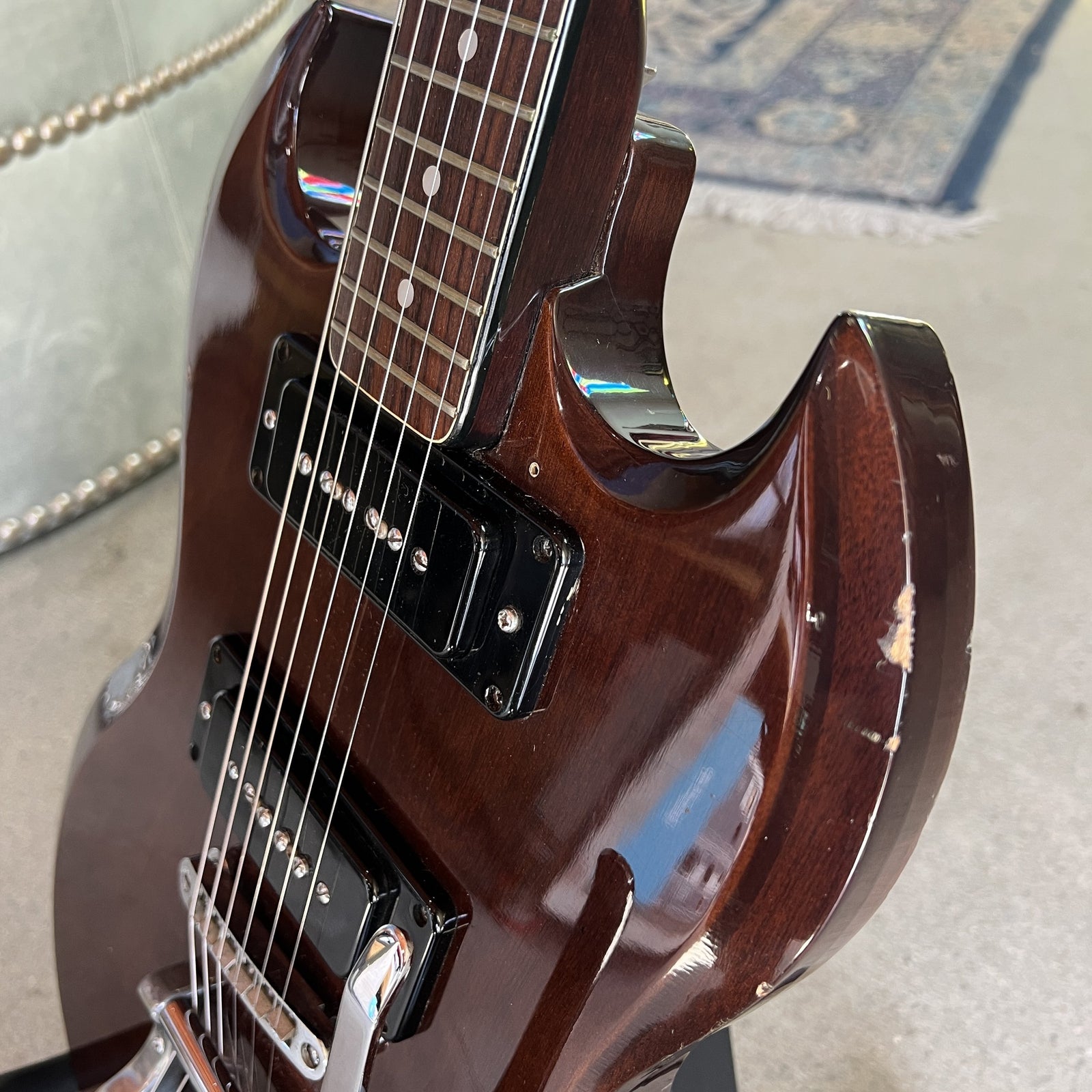 Lower body edge of the guitar showing authentic cosmetic playing wear and chipped finish