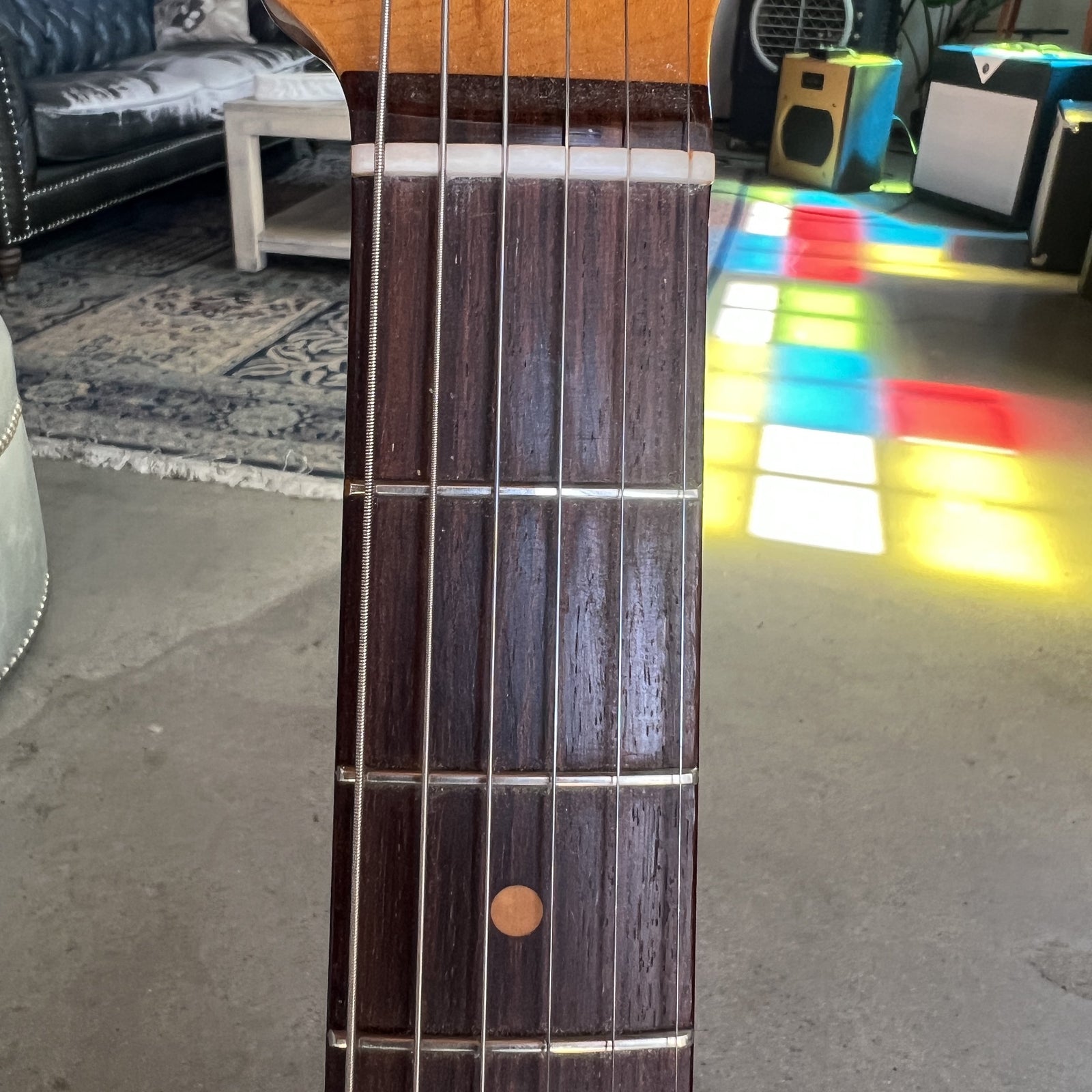 Close up of the slab rosewood fingerboard with clay dot inlays on the 1961 Stratocaster neck