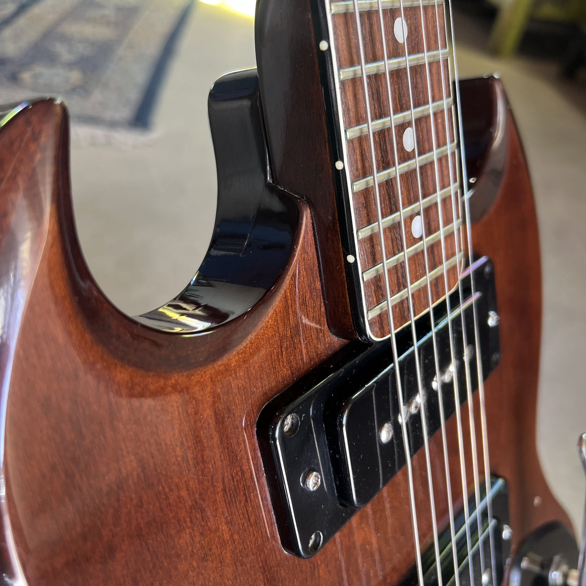 Side angle view showing the neck joint and the upper horn of the Cherry finished body