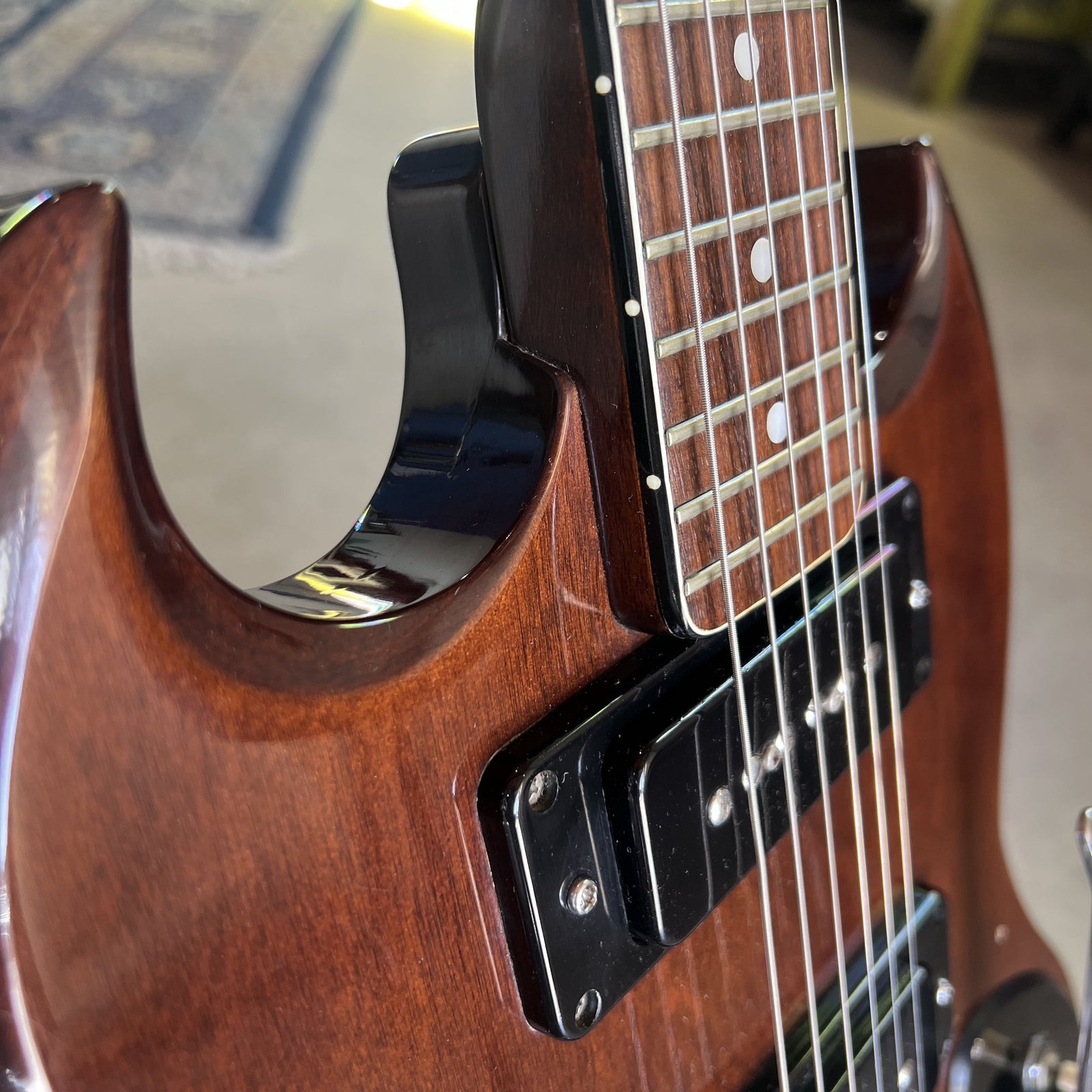 Side angle view showing the neck joint and the upper horn of the Cherry finished body
